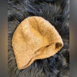 Tan cream fitted boutique hat . Small brown beads placed all over .